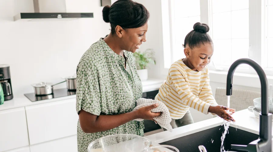 mother and daughter washing dishes